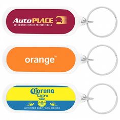 three different colored key chains with the words orange and corona extra on each one side