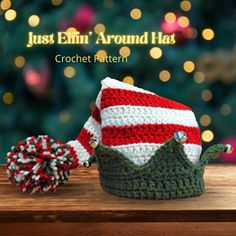 a crocheted christmas hat with a pom - pom on the side