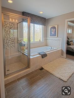 a bathroom with a walk in shower next to a bath tub