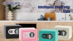 three electronic safes sitting on top of a wooden table in front of a kitchen