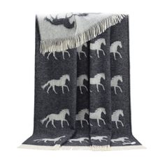 a black and white blanket with horses on it