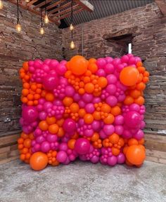 an orange and pink balloon sculpture in the middle of a room