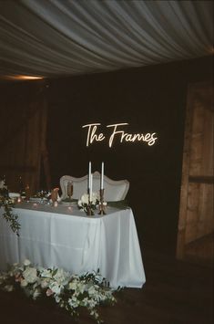 the table is set up with candles and flowers for an elegant wedding reception at the barn