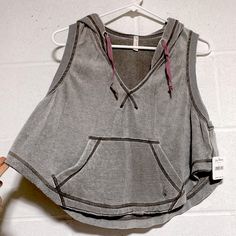 Faded Grey ( Dark Pine) Free People Sleeveless Cropped Hoodie With Ombre Purple Pink Ties And Kangaroo Pocket So Soft Activewear Dance Meadowbrook Pit To Pit 18” Length 18” Super-Soft And Cool On Hot Days Or For Workouts Brand New With Tags Comes In Sealed Original Bag Size Xs Same Or Next Day Shipping Gray Sleeveless Activewear For Loungewear, Sleeveless Tops For Fall Streetwear, Sleeveless Streetwear Tops For Fall, Gray Cotton Workout Vest, Sleeveless Cotton Activewear For Loungewear, Casual Sleeveless Gray Activewear, Casual Workout Tops With Drawstring Hood, Sleeveless Top With Drawstring Hood For Spring, Comfortable Hooded Workout Tops