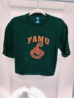 Florida A & M University (FAMU) crop top. It best fits a ladies medium but can fit size small for an oversized look. It is so cute and in very good condition. Green Cropped T-shirt For Streetwear, Casual Green Cropped T-shirt With Graphic Print, Casual Green Letter Print Crop Top, Casual Green Crop Top With Letter Print, Green Letter Print Crop Top, Green Cropped Cotton T-shirt With Letter Print, Fall Streetwear Cotton Crop Top, Green Cotton Cropped T-shirt With Letter Print, Green Crop Top For Streetwear In Spring