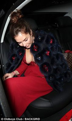 a woman sitting in the back seat of a car