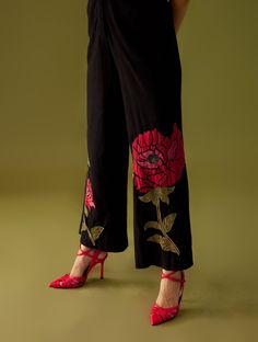 Editor's Note Black Kala Cotton Floral Applique Jumpsuit With Beadwork Ruffle Collar Color: Black Fabric: Cotton Care: Dry Clean Only About the Designer Chandrima celebrates diversity in cultures and craft forms creating ready-to-wear women wear for the urban woman of today. The brand embodies the idea of Indian handloom and craft merged with an international style. Label Chandrima stands for modern elegance and craftsmanship stemmed from the diversity and unity of the country. Festive Black Bottoms, Black Bohemian Sets For Spring, Bohemian Black Sets For Spring, Traditional Festive Spring Bottoms, Black Floral Embroidered Sets For Spring, Spring Black Sets With Floral Embroidery, Traditional Black Bottoms For Spring, Black Embroidered Sets For Spring, Embroidered Black Sets For Spring