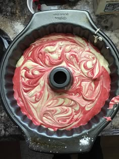 a cake pan with red and white frosting in it