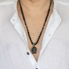 Black Power Skull Necklace is simple yet bold with natural Lava Rock stone and powerful Hematite stone beads combined with a steel skull pendant for an edgy look. This one of a kind necklace displays high quality materials and craftsmanship and its unique gothic style is sure to catch the eye. This necklace can be worn by both men and women. Lava Rock Stone is wonderful for calming emotions. It comes from raw energy and they are oldest stones in the world. Many users of lava stone believe it gro Spiritual Black Crystal Necklaces With Faceted Beads, Black Spiritual Crystal Necklace With Faceted Beads, Spiritual Black Crystal Necklace With Faceted Beads, Black Lava Stone Necklace For Gift, Black Lava Stone Round Bead Necklaces, Black Lava Stone Necklace Spiritual Style, Black Lava Stone Jewelry With Black Beads, Black Lava Stone Jewelry With Gemstone Beads, Black Spiritual Lava Stone Jewelry