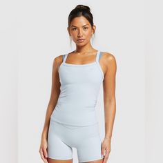 Sweat Wicking Ruched Details On Sides 75% Recycled Nylon, 25% Elastane Scoop Neck Gummy Gymshark Logo On Chest Ribbed Gymshark Ruched, Cut Tank Top, Active Tank Tops, Gymshark Women, Seamless Sports Bra, Muscle Tank Tops, Women Midi, Black Tank Tops, Blue Fashion