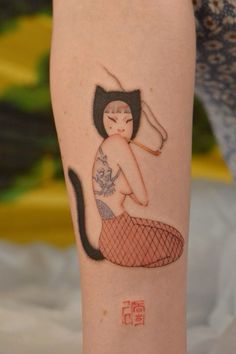 a woman with a cat tattoo on her arm