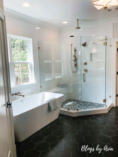 a bathroom with a large tub and walk in shower