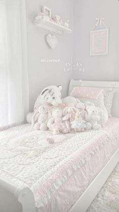 there is a white bed with teddy bears on it