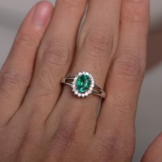 This is a gorgeous handmade creation. Its beauty is its simplicity & Elegance. The 6*8mm lab emerald is crafted in solid sterling silver and with rhodium plated. It's made to order and it will take about 7-10 days to make it. All item is sent in a beautiful gift box You can realize more lovely stuff clicking the link https://www.etsy.com/shop/knightjewelry?refshopsection_shophome_leftnav Please leave the correct address and you phone number for delivering successfully. Elegant Tsavorite Birthstone Ring, Classic 14k White Gold Emerald Ring For May Birthstone, Sterling Silver Brilliant Cut Rings For May Birthstone, Sterling Silver Rings With Brilliant Cut For May Birthstone, Oval Tsavorite White Gold Ring, Oval Tsavorite Ring In White Gold, Timeless Green Sterling Silver Ring, Silver Emerald Diamond Ring With Halo Design, Silver Diamond Ring With Emerald And Halo Design