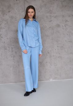 The NATURAL SILK BABY BLUE PANTS are a luxurious and elegant addition to your wardrobe. Made from of 50% natural silk and 50% cotton, these pants offer a soft and smooth texture that feels incredible against the skin. The baby blue color adds a touch of freshness and sophistication, perfect for both casual and formal occasions. Crafted with attention to detail, these pants feature a comfortable elastic waistband for a secure and adjustable fit. The wide-leg silhouette offers freedom of movement Elegant Blue Wide Leg Sets, Blue Long Pants Sets For Workwear, Blue Workwear Sets With Long Pants, Blue Long Pants Set For Work, Elegant Blue Pants For Loungewear, Baby Blue Pants, Chic Office Outfit, Baby Blue Color, Baby Blue Colour