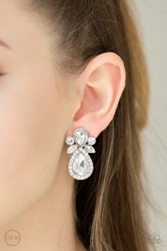 a woman wearing a pair of earrings with crystal stones on the side and an ear clip