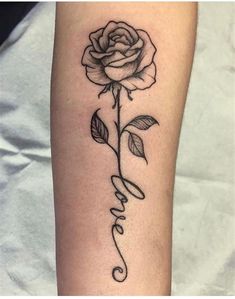 a rose with the word love written in cursive writing on its left arm