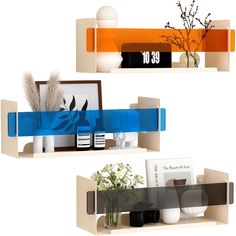 two shelves with vases and pictures on them, one is blue and the other is orange