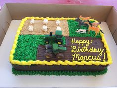 a birthday cake in the shape of a farm scene with animals and tractors on it