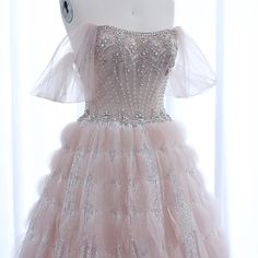 Indulge in pure luxury with our Dreamy Vow ball gown. Adorned with sparkling crystals and delicate ruffles, this blush pink dress is fit for a princess. Perfect for weddings, engagements, or any special occasion. Make a statement and turn heads with this elegant evening dress Elegant Organza Evening Dress For Quinceanera, Rhinestone Gown For Debutante Ball And Prom Season, Glamorous Tulle Ball Gown With Ruffles, Glamorous Ruffled Ball Gown For Debutante Ball, Rhinestone Ball Gown For Debutante Ball And Prom, Elegant Tulle Gown With Rhinestones, Floor-length Rhinestone Gown For Debutante Ball, Elegant Wedding Ball Gown With Rhinestones, Glamorous Gown With Rhinestones For Debutante Ball