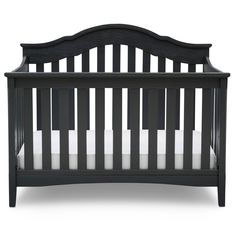 a black crib with white sheets on the top and bottom rails, in front of a white background