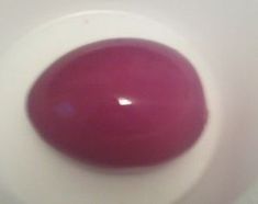 a close up of a red and white object in a bowl on a counter top