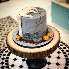 a birthday cake decorated with halloween decorations on a table