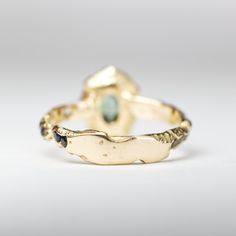 Details:One of a kind Bi-color Oval Peacock Montana Sapphire Ring. The stones have been set in 18k Yellow Gold (Eco Recycled Gold)Metal: 18K Yellow GoldStones: SapphireTCW: 1.15Please note: Each piece is truly unique from every other as a result of the cast in wood process. The wood defines the form of the metal and the settling of the stones. Stone color may vary, some stones may be buried, and the grain will individually shape the piece in completely unpredictable ways. Only the care and atten Luxury Tourmaline Oval Cabochon Jewelry, Luxury Tourmaline Jewelry With Oval Cabochon, Luxury Tourmaline Jewelry In Oval Cabochon Shape, Oval Multi-stone Emerald Gemstones, Oval Yellow Gold Emerald Ring With Multiple Stones, Oval Yellow Gold Emerald Ring With Multi-stone, One Of A Kind Oval Yellow Gold Jewelry, Yellow Gold Sapphire Ring With Open Ring Style, Yellow Gold Sapphire Open Ring In Unique Style