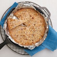 a baked dish on a wire rack with blue napkins and a black spatula