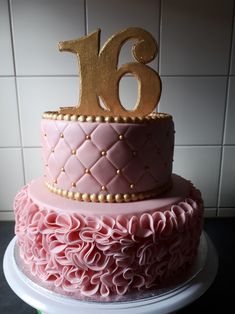 a pink and gold birthday cake with the number eighteen on it's tiers