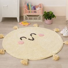 a child's room with a rug that has a smiley face drawn on it