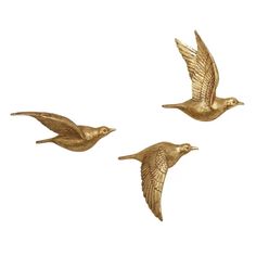 three gold birds flying in the air