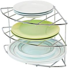 three plates stacked on top of each other in a wire rack with two bowls and one plate