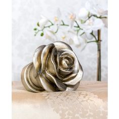 a silver rose sitting on top of a table