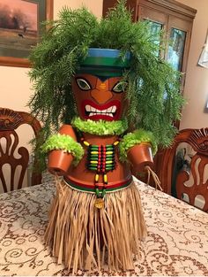 a tiki doll sitting on top of a table