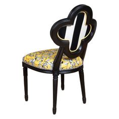 a black and yellow chair with a heart shaped backrest on it's seat