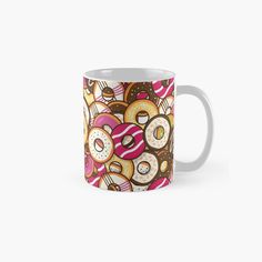 a coffee mug filled with donuts and sprinkles