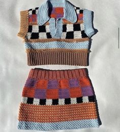 two pieces of crocheted clothing sitting on top of each other