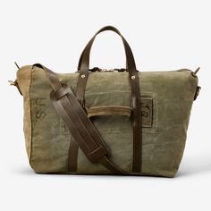 Created with heritage in mind, each of these bags is crafted from authentic salvaged military canvas, meaning each is entirely unique. Built to withstand another 50 years of adventures, this travel bag features 100% full-grain leather detailing, including brass hardware. An internal pocket enhances organization, while the detachable, adjustable leather strap with a shoulder pad ensures a comfortable carry during your journeys..View Repurposed Military Travel Bag by WP Standard on our site for mo Vintage Travel Bag With Waxed Finish, Vintage Waxed Finish Travel Bag, Military Style Rectangular Travel Bag, Travel Bag With Leather Patch And Duck Canvas, Travel Bag In Duck Canvas With Leather Patch, Vintage Duffle Bag With Leather Handles For Overnight Trips, Vintage Bags With Leather Patch For Everyday, Military-style Khaki Travel Bags, Military Style Khaki Bags For Travel