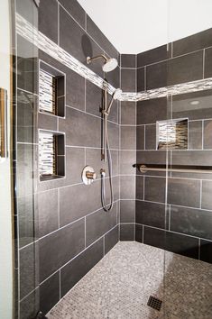 a walk in shower sitting inside of a bathroom next to a tiled wall and floor