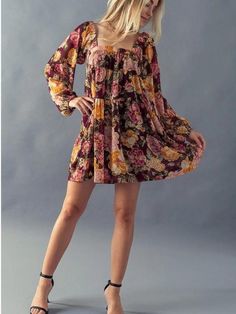 Fall in Love in this Floral Babydoll Dress. The dress has long cuffed sleeves, a trendy square neckline, and a tiered babydoll design. The mini length gives the dress a flirty vibe paired with some knee-high boots. The floral print has beautiful burgundy, orange, and pink Fall hues making this piece a must-have this season. The dress has an inner lining with a sheer overlay. Fabric: 100% Polyester (Self and Lining) Includes x1 Dress. Sizes S-M-L; Regular Sizing. Flowy Square Neck Mini Dress For Fall, Fall Mini Dress With Ruffles And Square Neck, Flowy Square Neck Mini Dress With Ruffles, Fall Mini Dress With Ruffle Hem And Square Neck, Fall Square Neck Dress With Ruffle Hem, Fall Floral Print Mini Dress With Square Neck, Floral Print Mini Dress With Square Neck For Fall, Floral Print Square Neck Mini Dress For Fall, Flowy Tiered Mini Dress For Fall