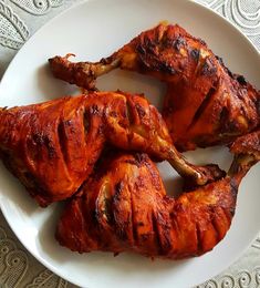 three pieces of cooked chicken on a white plate