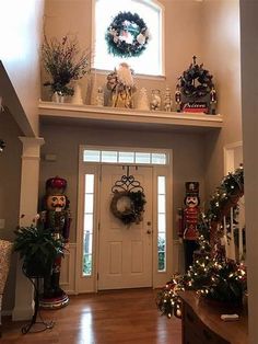 the entryway is decorated for christmas with wreaths and decorations