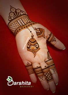 the hand is decorated with henna designs