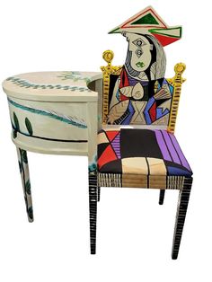 a chair with a painting on it next to a small table that is shaped like a woman's head