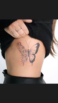 a woman's back with a butterfly tattoo on her lower body and the bottom part of her stomach