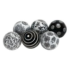 several black and white balls with designs on them