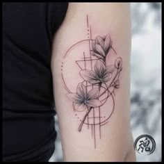 a woman's arm with flowers on it and a geometric design in the background