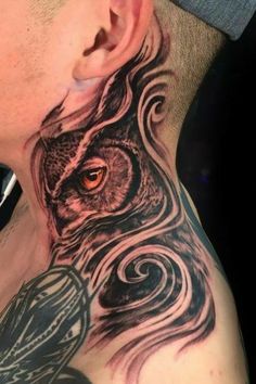 a man with an owl tattoo on his neck