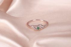 This elegant 925 Sterling Silver ring features a natural emerald at its center, surrounded by sparkling zirconia stones. The emerald's light green hue contrasts beautifully with the shimmering zirconia, creating a mesmerizing effect. Designed as a promise ring, it symbolizes love and commitment with its radiant and delicate appearance. This exquisite ring is a perfect gift for mom, celebrating her with a touch of timeless beauty and sophistication Ring Description: - - - - - - - - - - * Material Green Diamond Birthstone Ring For Promise, Green Emerald Ring With Diamond Accents For Promise, Green Emerald Promise Ring With Diamond Accents, Green Diamond Dainty Birthstone Ring, Dainty Green Diamond Birthstone Ring, Dainty Green Diamond Ring For Anniversary, Dainty Green Diamond Anniversary Ring, Green Cubic Zirconia Promise Ring, Green Diamond Ring As A Gift